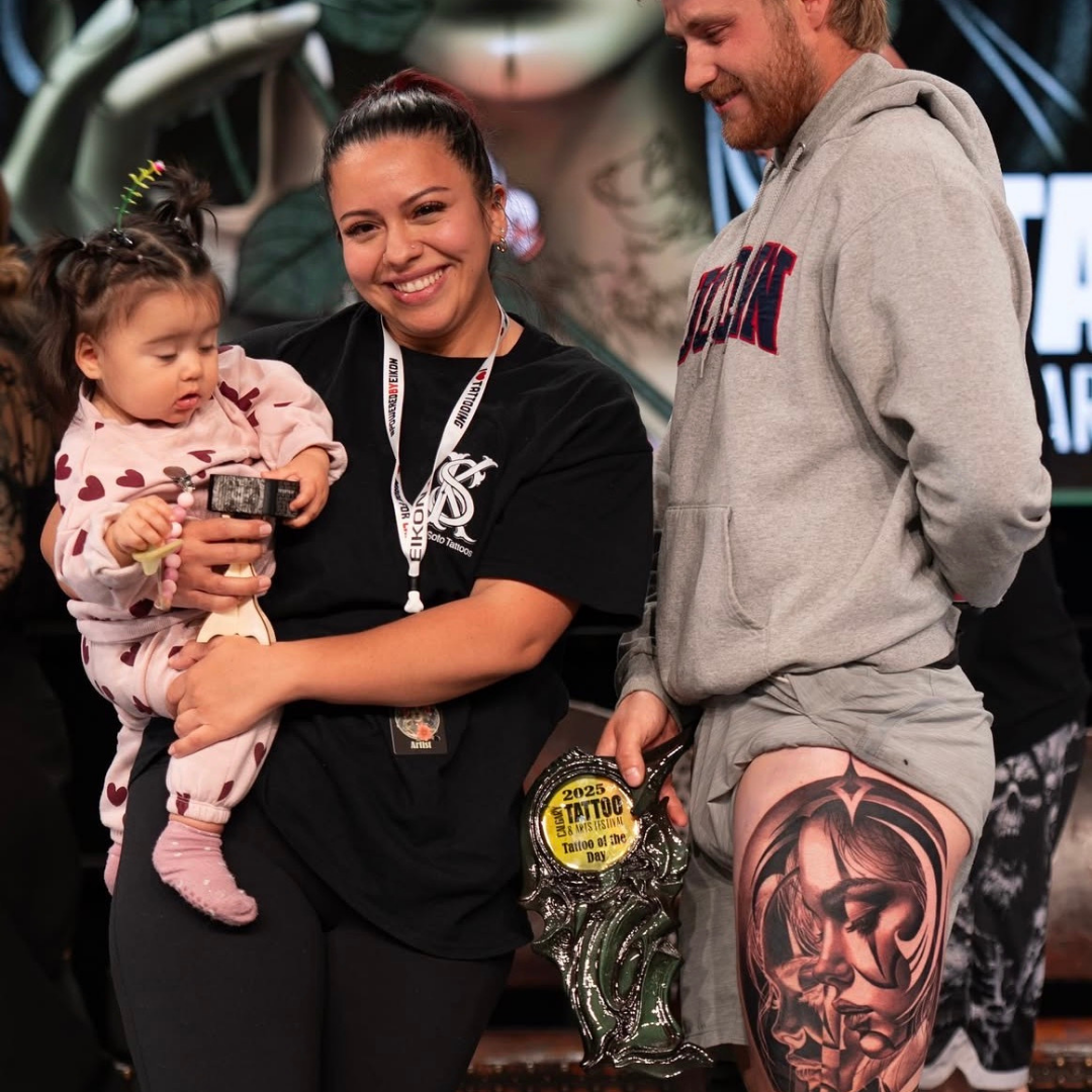 Keila Soto winning award with her baby